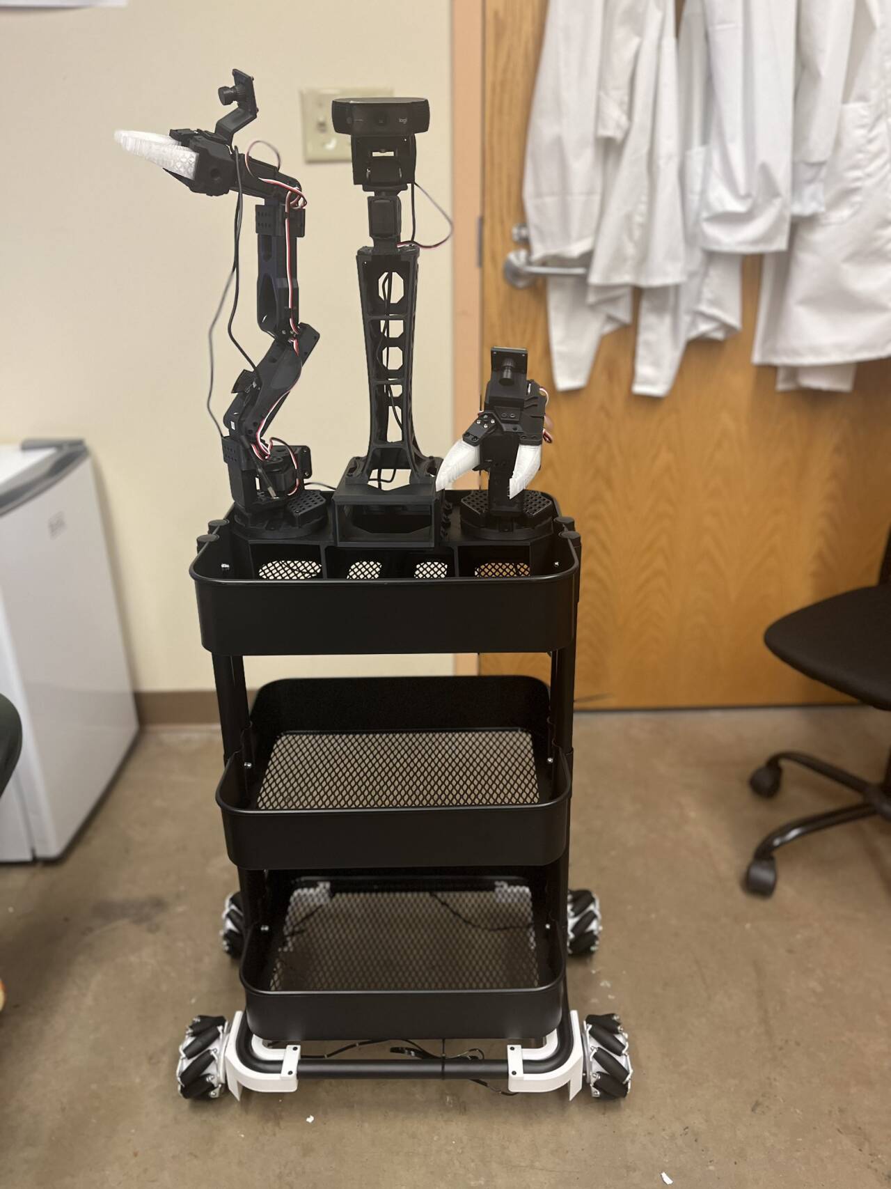XLeRobot dual-arm mobile manipulator fully assembled on a lab cart